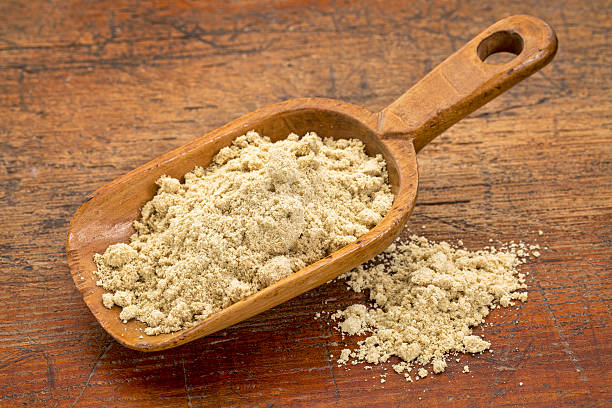 a rustic scoop of rice bran against grunge wood